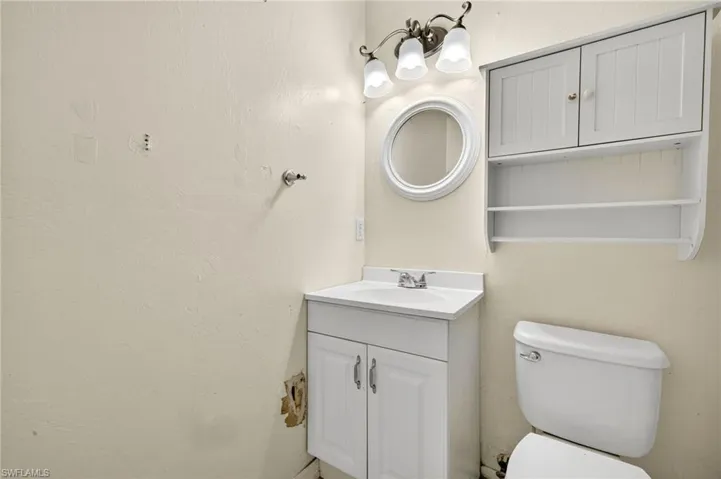 Half bath featuring vanity and a chandelier