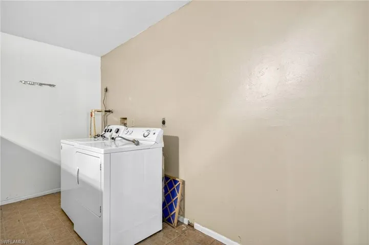Washroom featuring washer / dryer