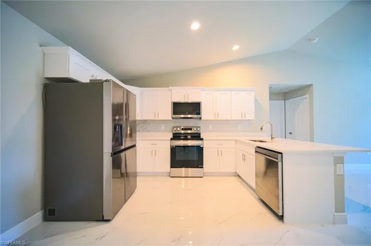 The Kitchen Comes With Quartz Countertops, Tile Backsplash, Stainless Steel Appliances, And White Soft Touch Wooden Cabinets With Brushed Nickle Handles!