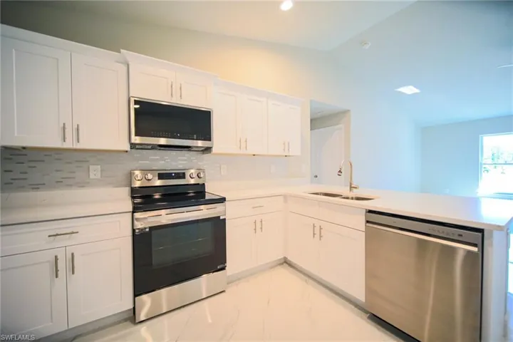 The Kitchen Comes With Quartz Countertops, Tile Backsplash, Stainless Steel Appliances, And White Soft Touch Wooden Cabinets With Brushed Nickle Handles!