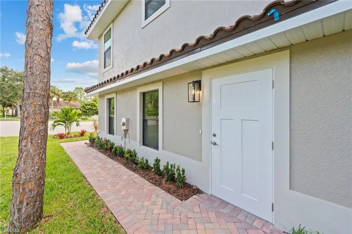 Doorway to property with a lawn