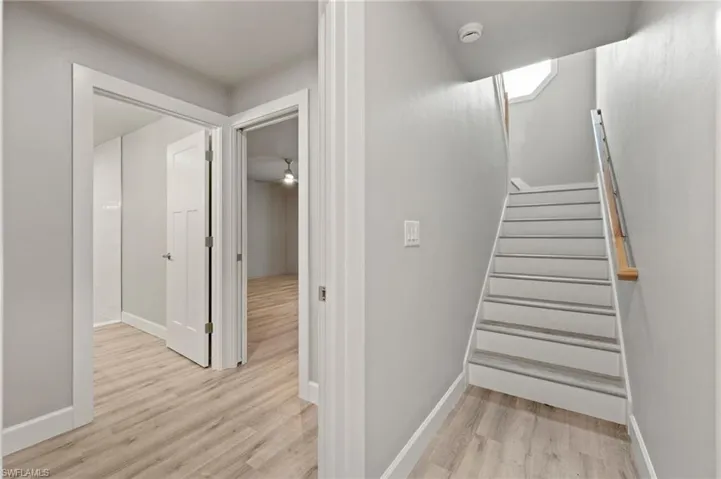 Staircase with light wood-type flooring