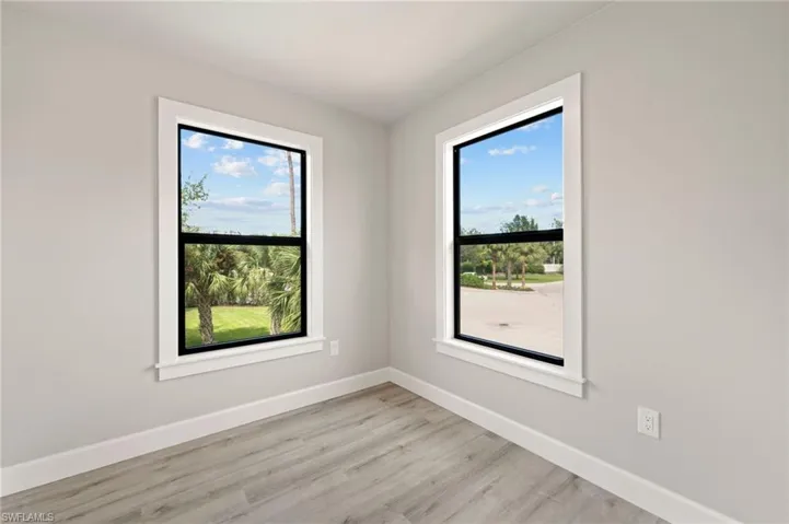 Spare room with light wood-type flooring and plenty of natural light
