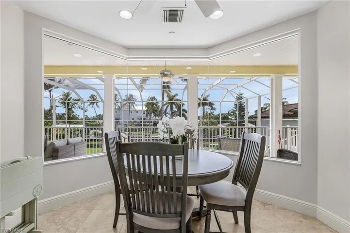 Dining space with light tile patterned floors, ceiling fan, a sunroom, and recessed lighting