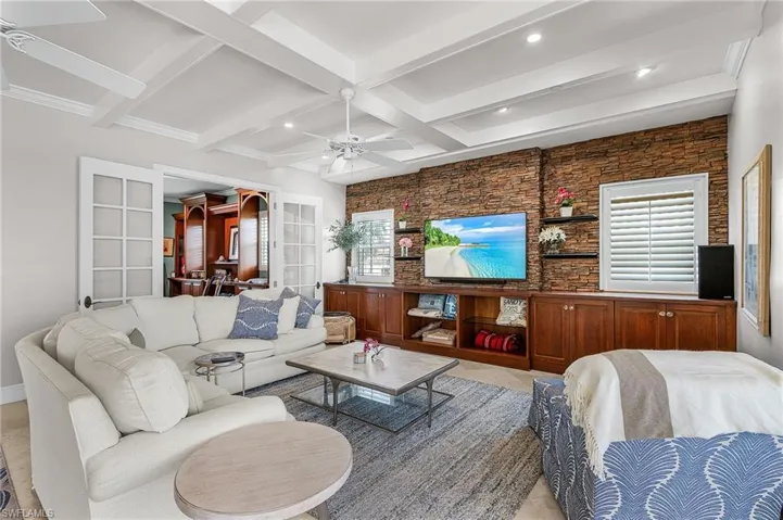 Living area featuring beam ceiling, coffered ceiling, recessed lighting, and ceiling fan