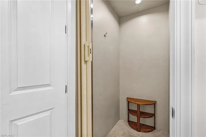 Hallway featuring elevator, recessed lighting, and tile patterned floors