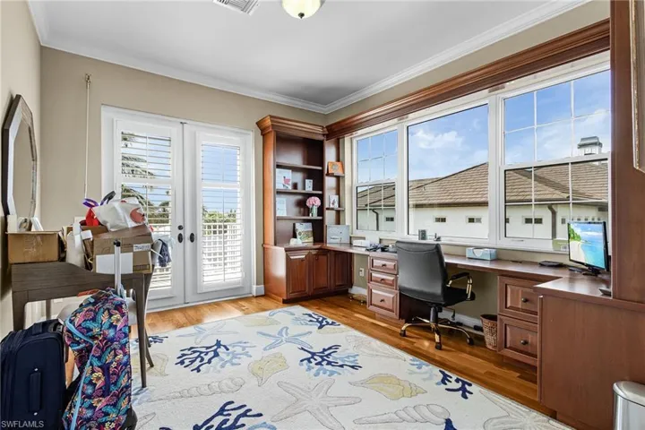 Office featuring french doors, light wood-type flooring, and ornamental molding