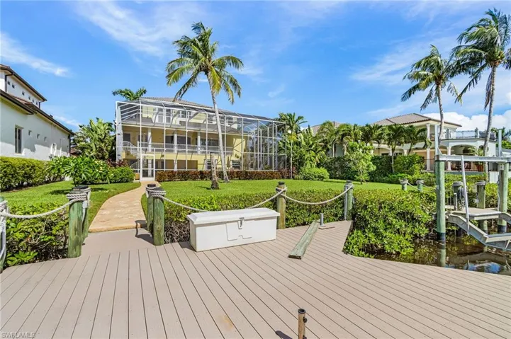 Dock area featuring a lawn and a lanai