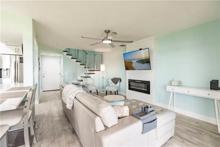 Living room with light wood-type flooring and ceiling fan