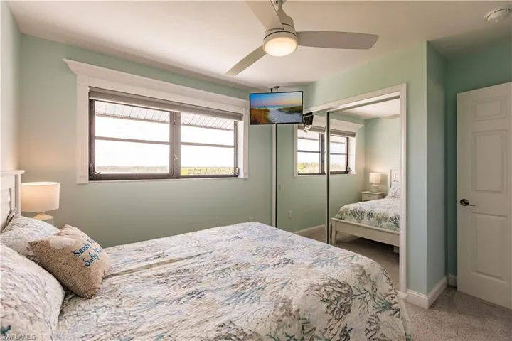 Carpeted bedroom featuring a closet and ceiling fan