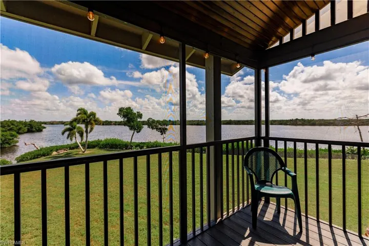 Wooden deck featuring a yard and a water view