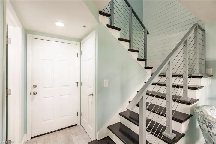 Stairs featuring hardwood / wood-style flooring