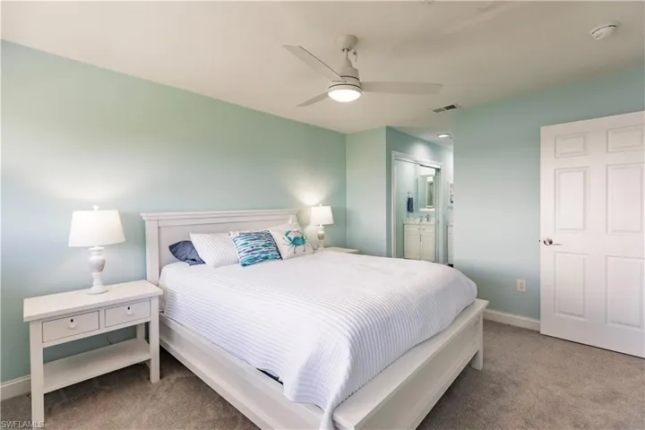 Bedroom featuring connected bathroom, ceiling fan, and carpet