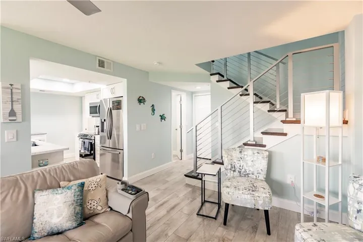 Living room featuring light hardwood / wood-style flooring and a raised ceiling