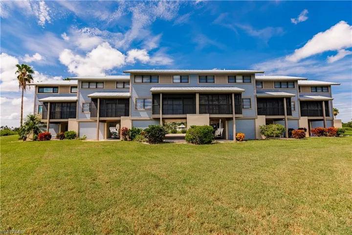 Rear view of property with a yard
