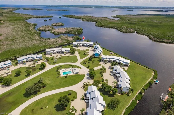 Birds eye view of property with a water view