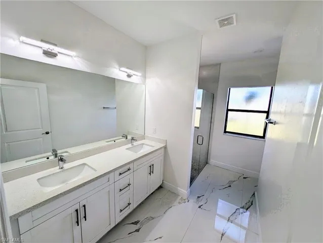 Bathroom featuring vanity and walk in shower