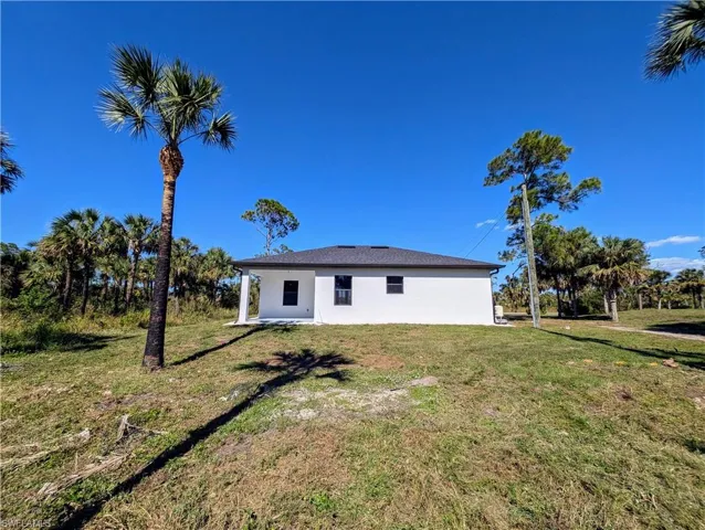 Rear view of house with a lawn