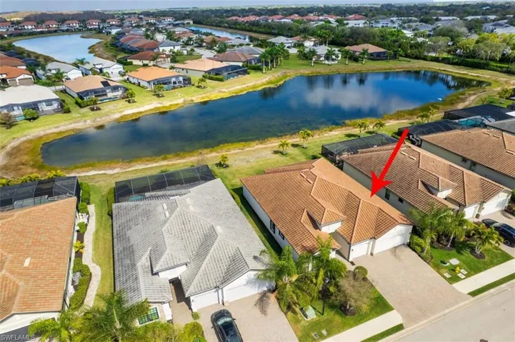 Aerial view of residential area featuring a large body of water
