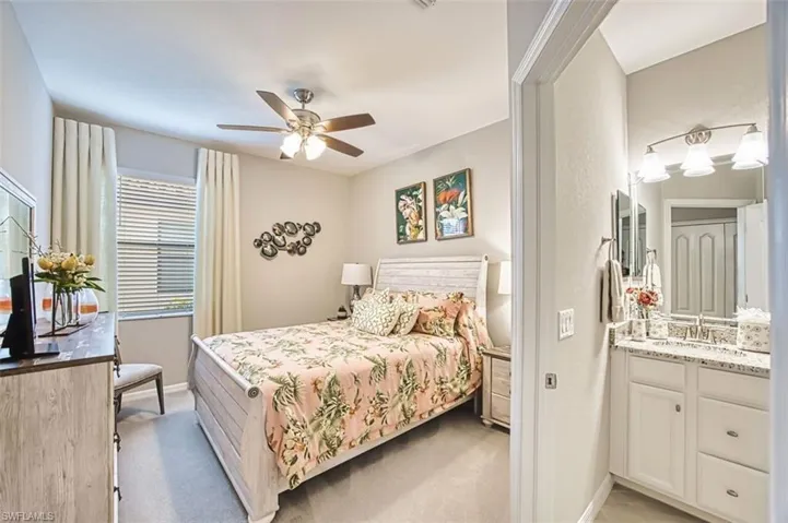Bedroom with light colored carpet and ceiling fan