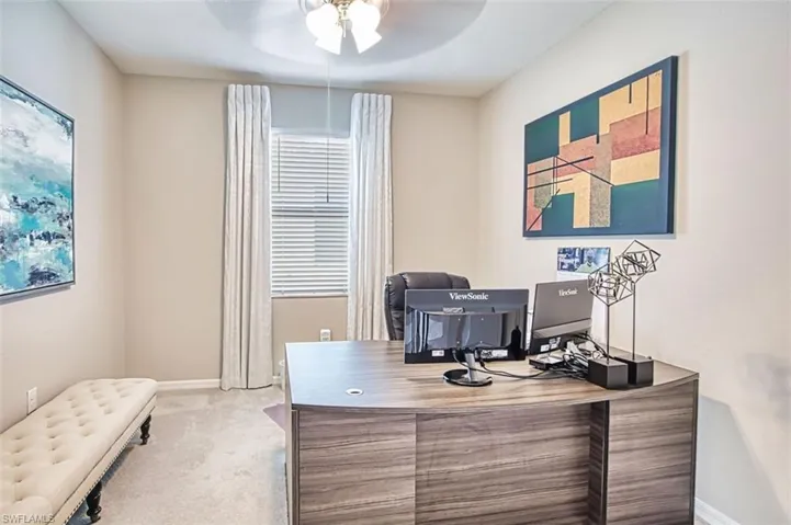 Office featuring a ceiling fan and light carpet