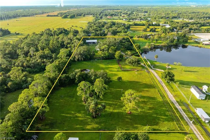Aerial view featuring a water view and a rural view