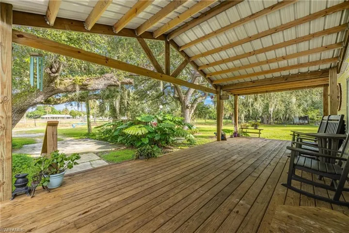 Wooden terrace featuring a yard