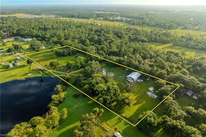 Birds eye view of property featuring a water view and a rural view