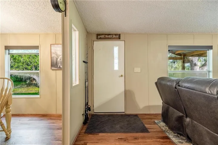 Foyer entrance featuring a textured ceiling and light wood-type flooring