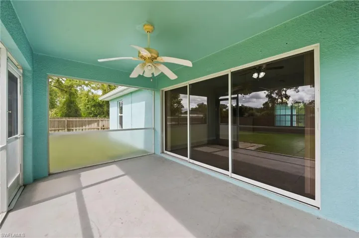 Unfurnished sunroom featuring ceiling fan