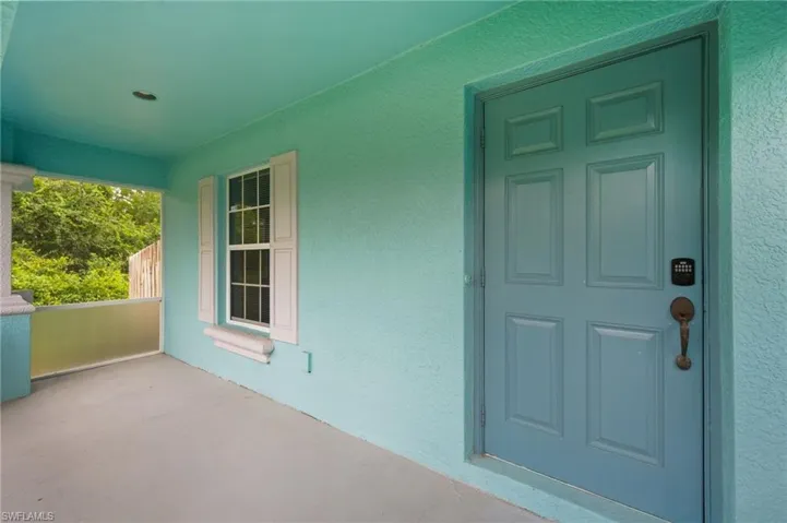 Doorway to property featuring stucco siding