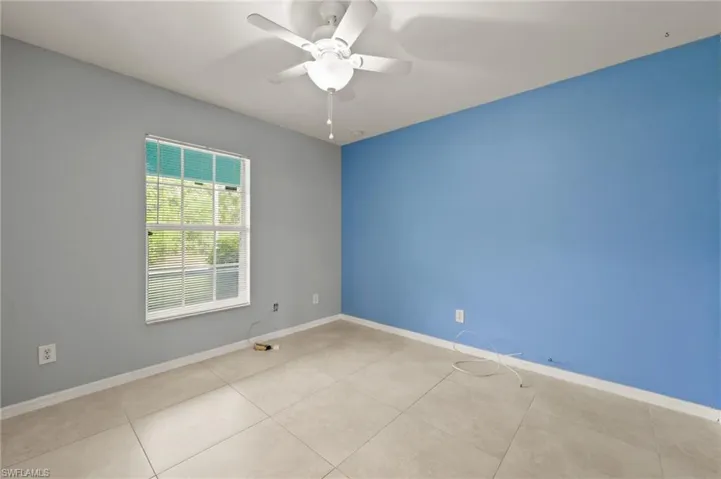 Unfurnished room with a ceiling fan and tile patterned floors