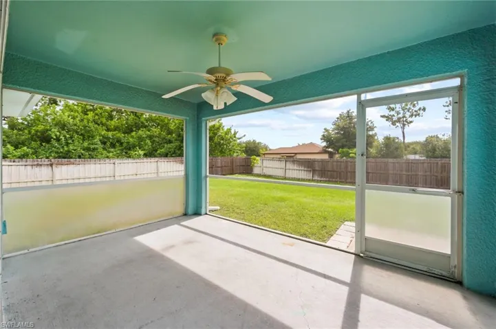 Unfurnished sunroom featuring a ceiling fan
