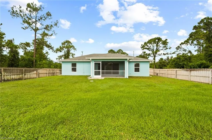 Rear view of property with a fenced backyard and stucco siding