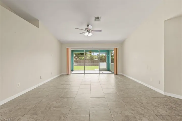 Spare room with ceiling fan and baseboards