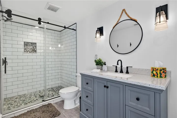 Bathroom with vanity and a glass shower