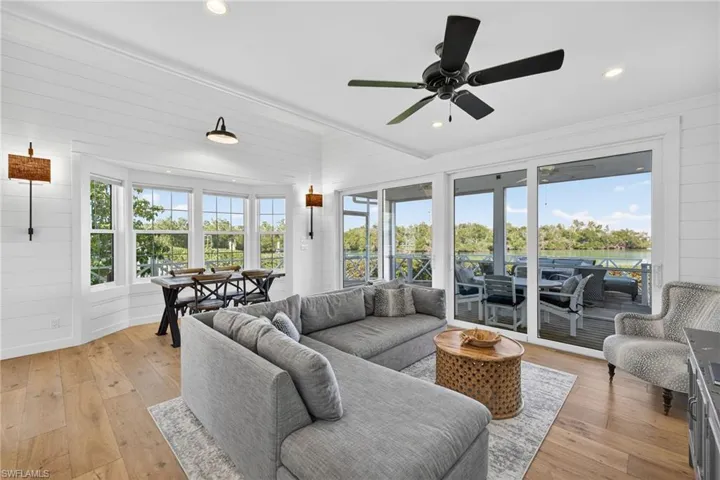 Living room, facing the back screened porch and open deck area to a small bay area leading to Pine Island Sound
