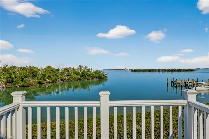 Deck off 2nd floor bedroom with view across  communal dock and across a small bay out to Pine Island Sound