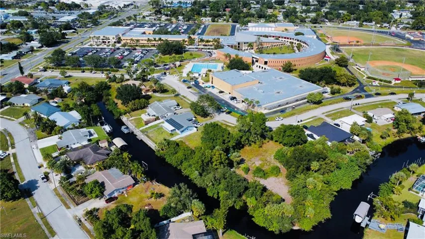 Aerial view of property's location with nearby suburban area and a large body of water