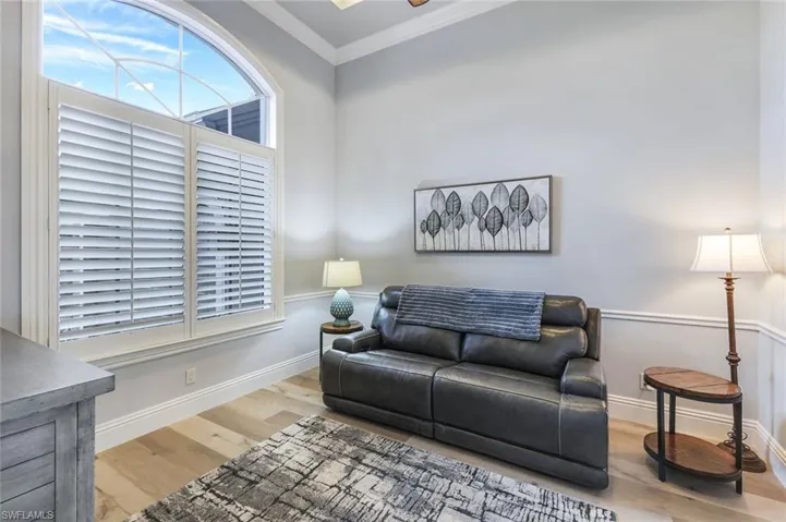 Living room featuring hardwood / wood-style flooring and crown molding