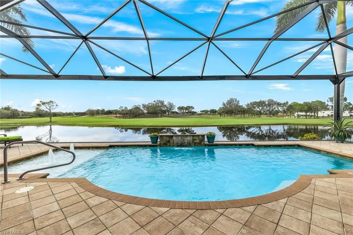 View of pool with a water view, pool water feature, and a lanai