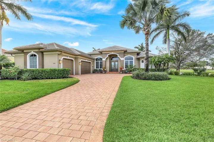 Mediterranean / spanish-style house featuring a garage and a front lawn