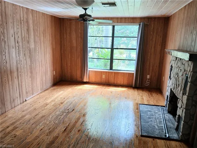Living Room with a wood burning fireplace and view of front yard