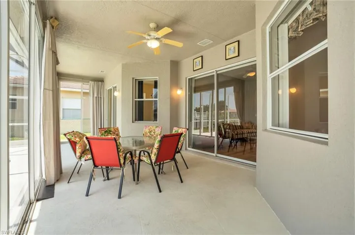 Sunroom featuring a wealth of natural light and ceiling fan