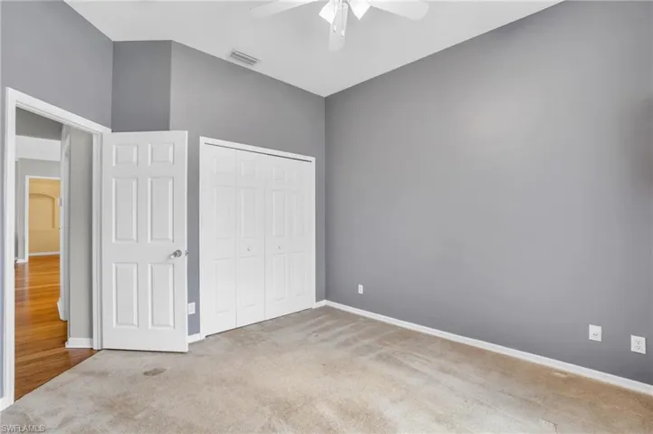 Unfurnished bedroom with hardwood / wood-style flooring, a closet, and ceiling fan