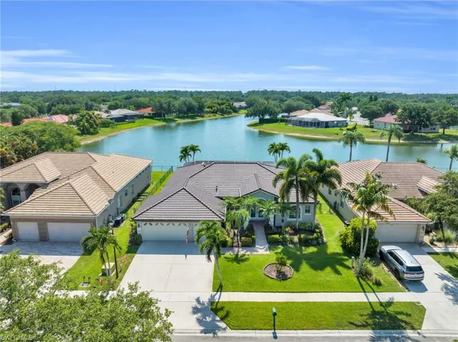 Birds eye view of property with a water view