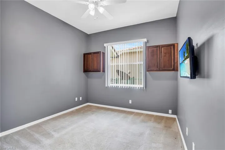 Spare room with light colored carpet and ceiling fan