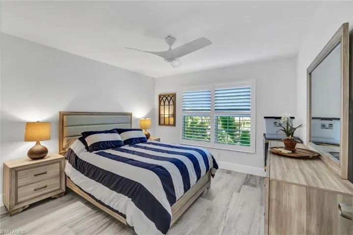 Bedroom with ceiling fan and light hardwood / wood-style floors
