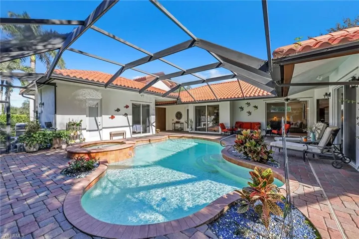 Rear view of house featuring a tiled roof, stucco siding, a patio area, a pool with connected hot tub, and a ceiling fan