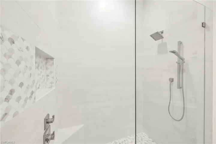 Full bath featuring a tile shower